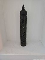 Full view of ebonized hardwood cylindrical incense holder showing openwork body and lid