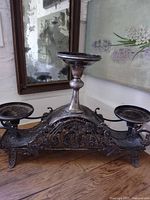 Full view of silver-plated centerpiece stand displaying central pedestal and side holders