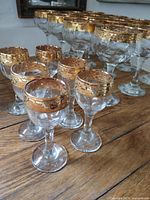 Group of wine and liqueur glasses displaying gold bands
