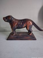 Profile view of cast iron dog nutcracker closed