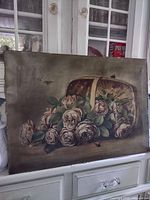 Front view of unframed oil painting showing roses in basket and bee detail