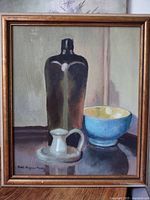 Front view of framed still life painting showing bottle, pitcher and bowl