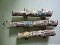 Front view of ceramic wall pocket showing three glazed tubes