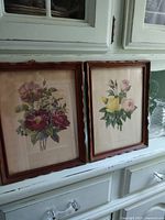 Both framed prints on cabinet