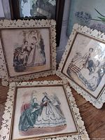 Three framed fashion prints side by side