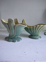 Two green glazed ceramic Beauce Ware planters, flower and shell forms