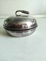 side view of silver-plated lidded curling trophy