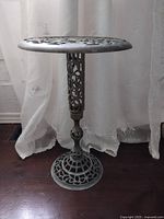 Full view of brass pedestal stand showing top, column and base