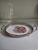 Top view showing oval tray, ceramic centre and handles