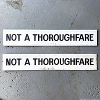 Both NOT A THOROUGHFARE signs front side