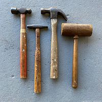 All four hammers lined up on concrete