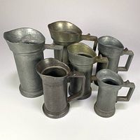 Front group view of six pewter measures assorted sizes
