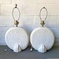 Front view of both white round table lamps