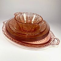 Stacked view of all six pink Depression glass pieces
