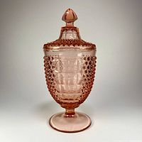 Full view of pink depression glass candy jar with lid