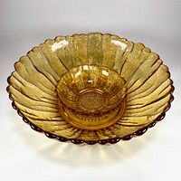 Large and small amber glass sunflower bowls nested
