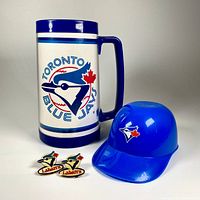 Lot overview showing beer stein, two pins, and helmet