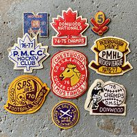 Front view showing all eight chenille patches with text and graphics