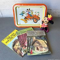 Group shot of tray, coin bank and three books