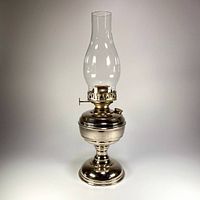 Full view of assembled nickel-plated oil lamp with chimney