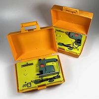 Both open Powermite cases showing jigsaw (left) and drill (right) in trays