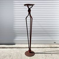 Full view of wrought iron plant stand standing upright