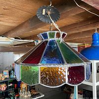 Full view of stained glass swag lamp hanging from ceiling