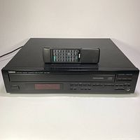 Front view of Yamaha CDC-645 CD changer with remote on top