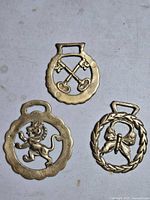 All three brass horse brasses showing designs and size comparison