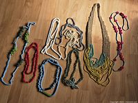 All 11 necklaces laid out showing colours, lengths and pendants