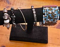 Five bracelets displayed on stand