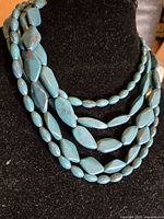 Necklace on display bust showing bead shapes and layered strands