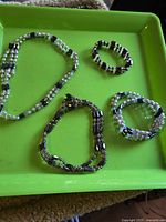Four magnetic bead strands on green tray showing overall quantity and design