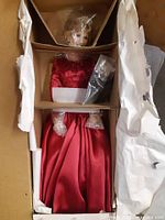Doll in original inner carton with protective wrapping