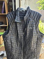 Front view of black quilted L.L.Bean down vest showing zipper and chest pocket