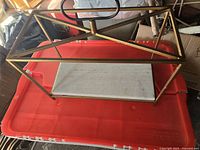 Oblique view showing full brass frame, marble base, and handle