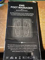 Retail box front showing EMS Foot Massager branding and product image