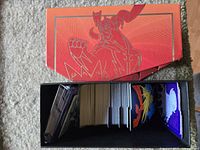 Overall view of red Zamazenta elite trainer box with cards inside