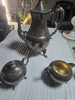 Full view of all three pieces showing form and footed bases