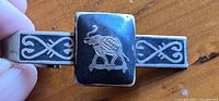 Front of sterling tie clip with elephant design and scrollwork