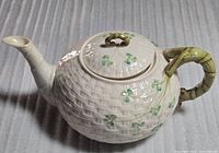 Full view of Belleek Shamrock teapot showing basketweave body, twig handle and spout