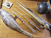 Group view of carved koi fish, sphere, six sticks, small block