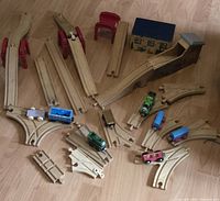 Overview of train tracks, trains, risers and buildings on floor