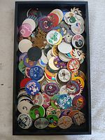 Top view of tray filled with assorted pogs