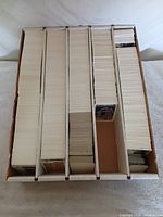 Top view of five-row cardboard box filled with baseball cards