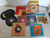 Group shot of all 11 records and book sets