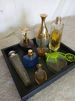 All seven cologne bottles arranged on tray
