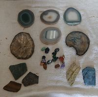 Overview showing agate slices, agatized wood slice, tumbled stones and mineral slabs