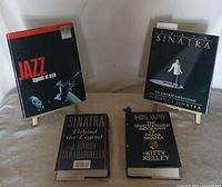 Group shot of all four hardcover books displayed