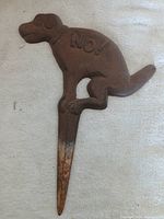 Full view of cast iron dog stake with rust